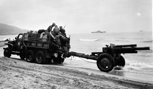 Old 2.5 ton truck & 105mm howitzer on a beach